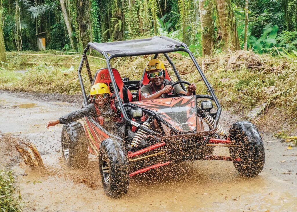 Couple driving a UTV buggy through jungle terrain at Pertiwi Adventure Bali