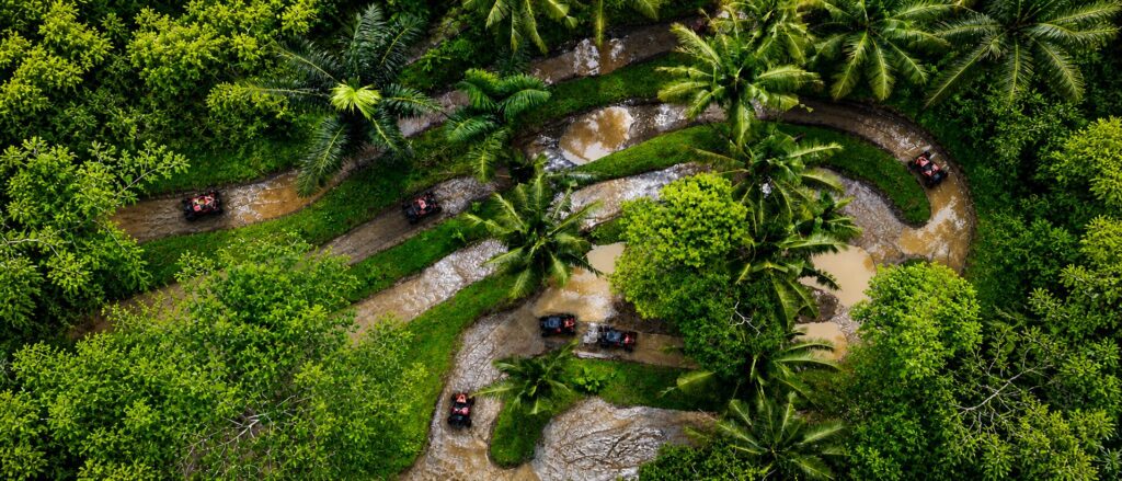 Drone view of the Jurassic jungle UTV track surrounded by dense tropical forest and off-road adventure trails at Pertiwi Adventure Bali