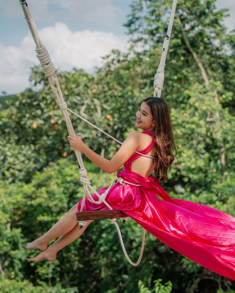 Tropical swing attraction set among tall palm trees and forest scenery