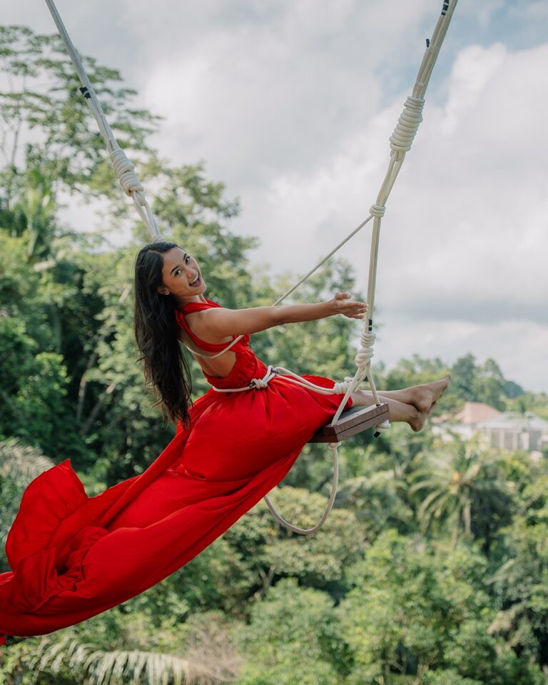 Visitor enjoying jungle swing with panoramic Bali nature backdrop