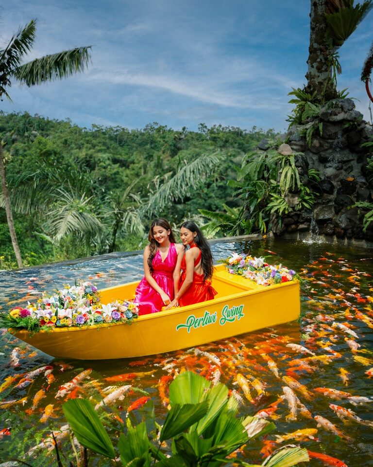 Koi pond boat ride at Pertiwi Jungle Swing surrounded by tropical garden and colorful koi fish