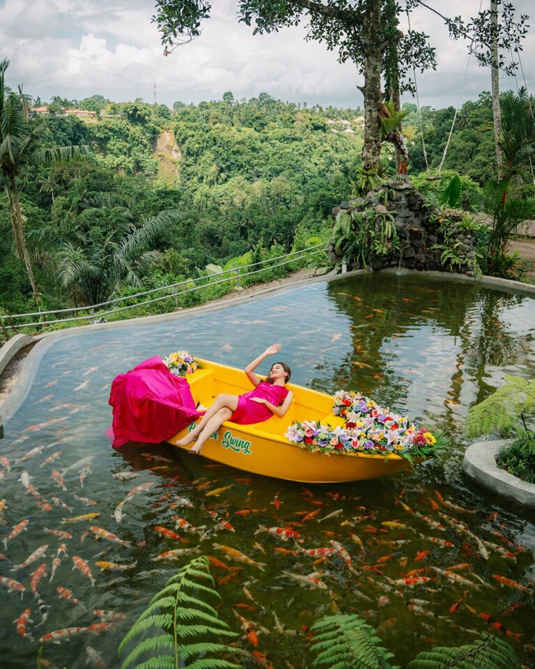 Koi pond boat attraction at Pertiwi Jungle Swing with clear pond water and tropical garden surroundings