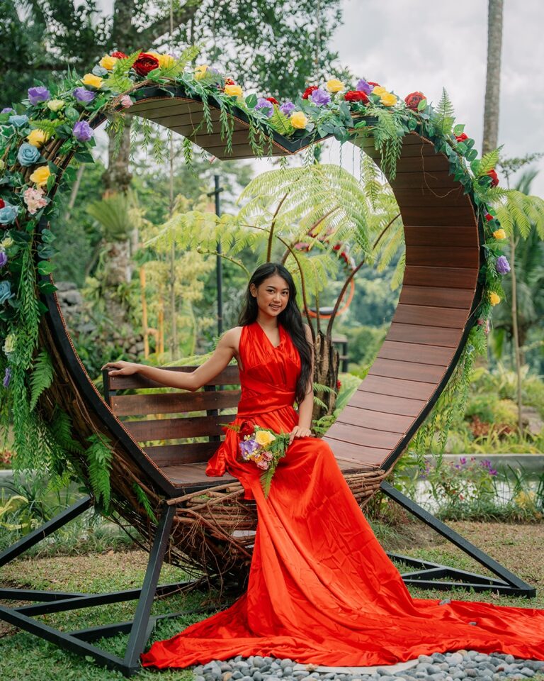 Elegant woman relaxing on the Love Seat at Pertiwi Jungle Swing with jungle views