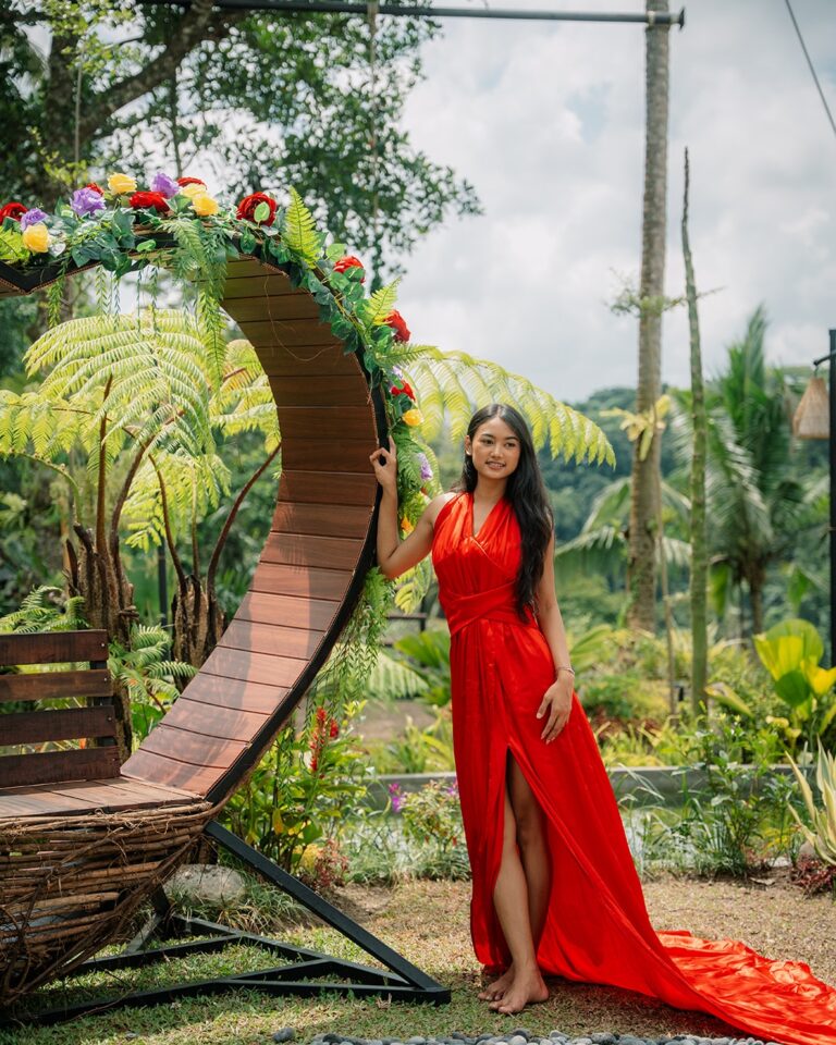 Beautiful woman posing at the Love Seat Pertiwi Jungle Swing surrounded by tropical Bali scenery