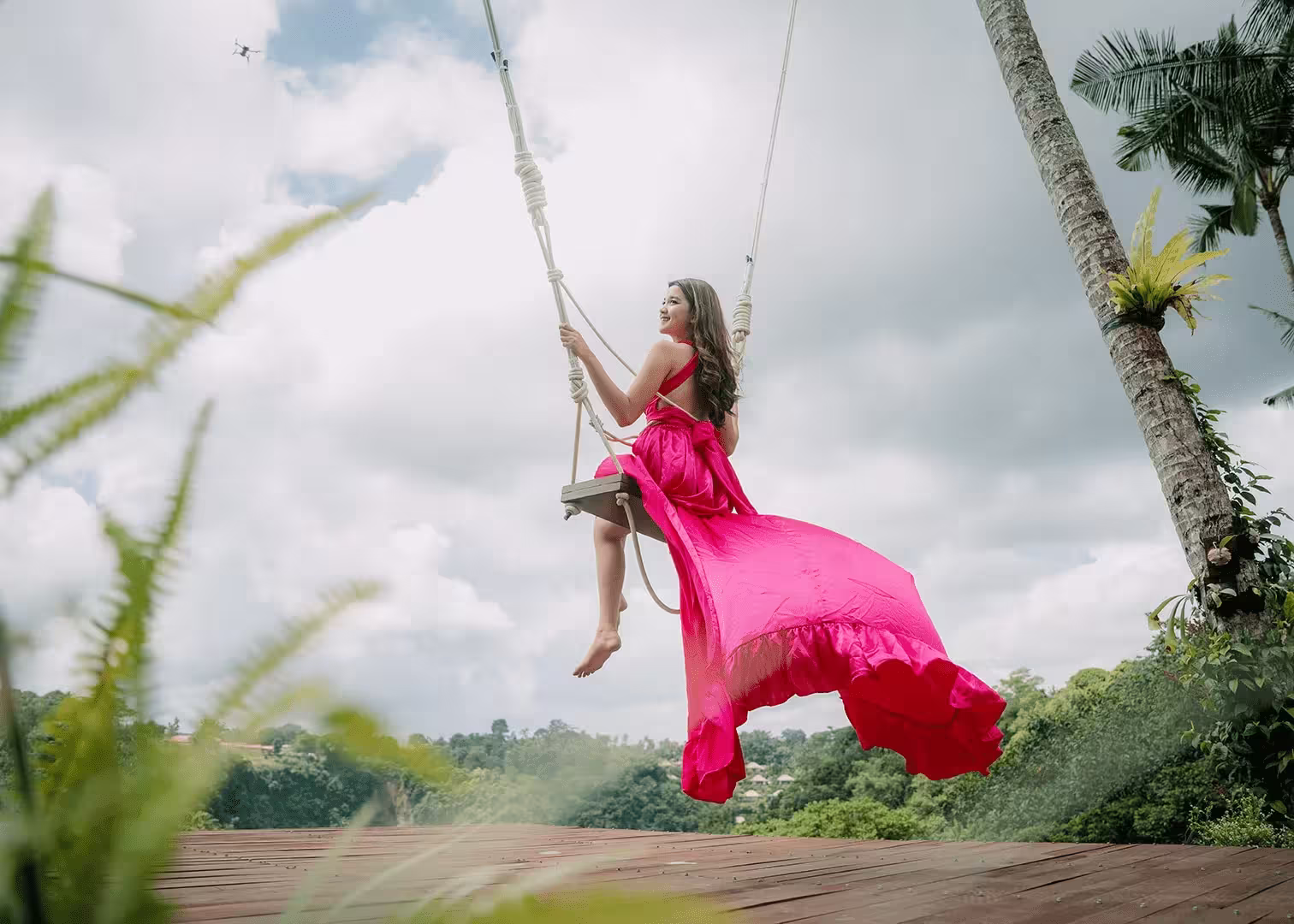 Woman enjoying the jungle swing experience at Pertiwi Jungle Swing by Pertiwi Adventure surrounded by tropical scenery