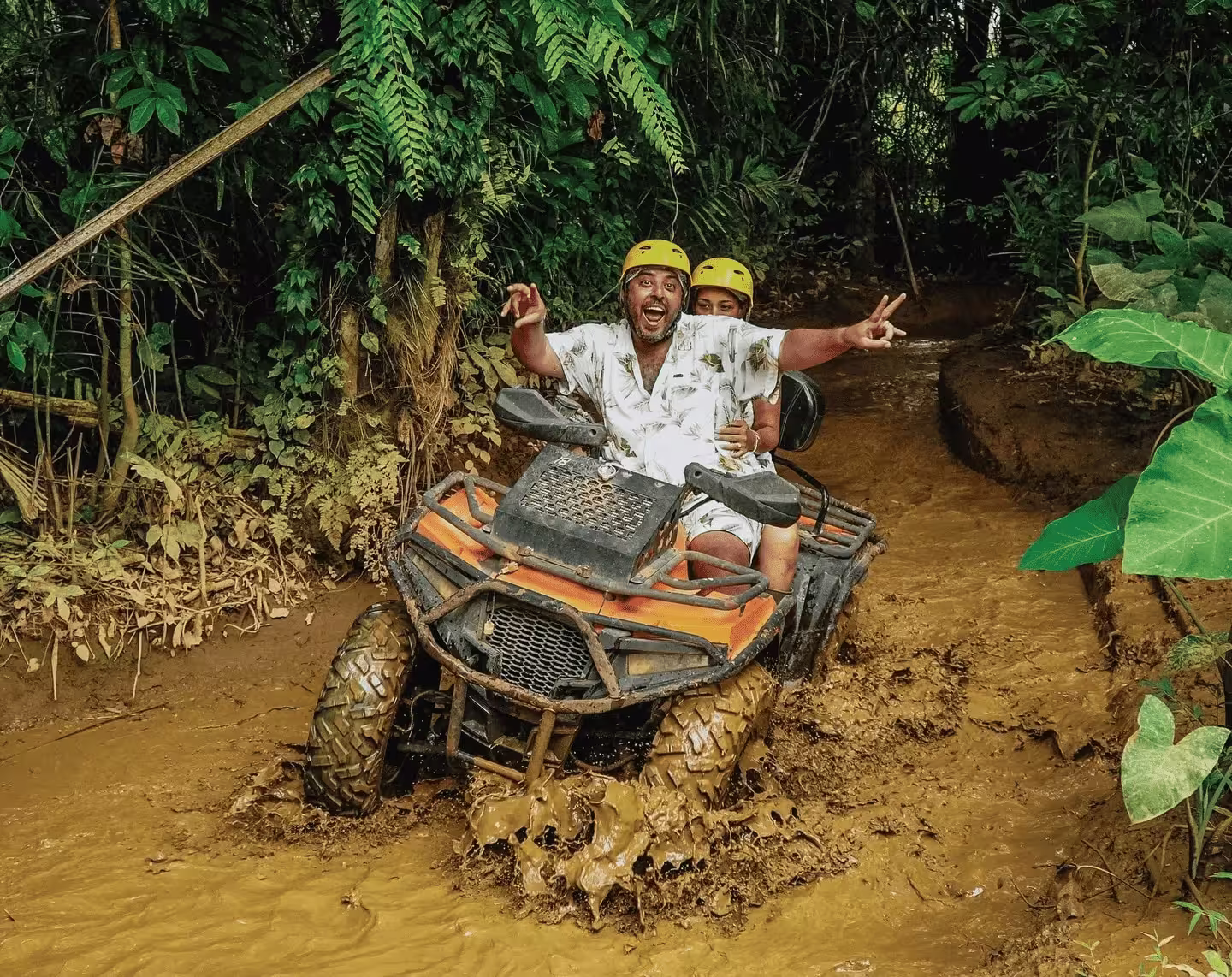 ATV riders exploring muddy jungle trails during an adventure tour at Pertiwi Adventure