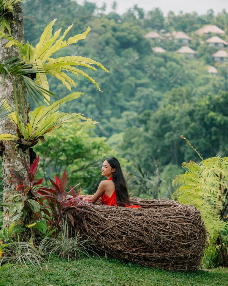 Woman posing gracefully on the Love Seat at Pertiwi Jungle Swing Bali